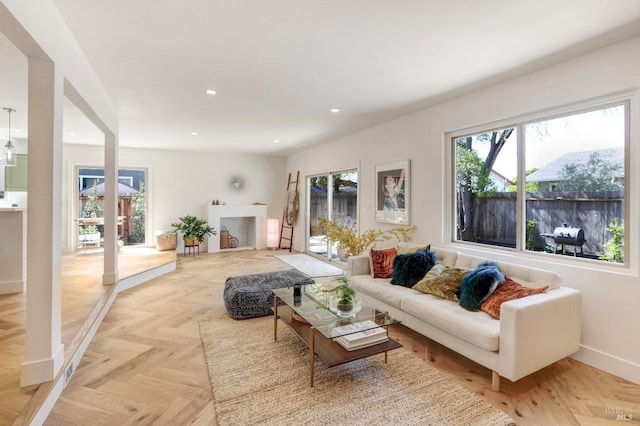 living room with baseboards, a fireplace, and recessed lighting