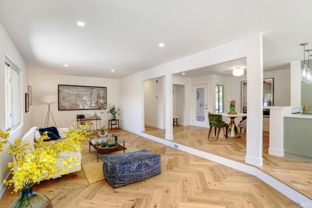 living area featuring baseboards and recessed lighting