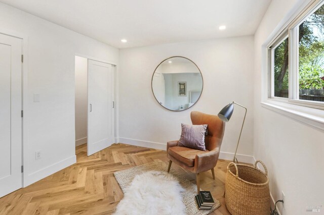 sitting room with baseboards and recessed lighting