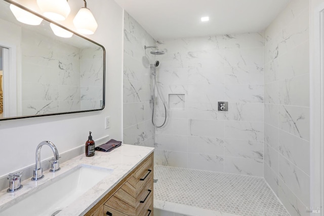 full bathroom featuring vanity and tiled shower