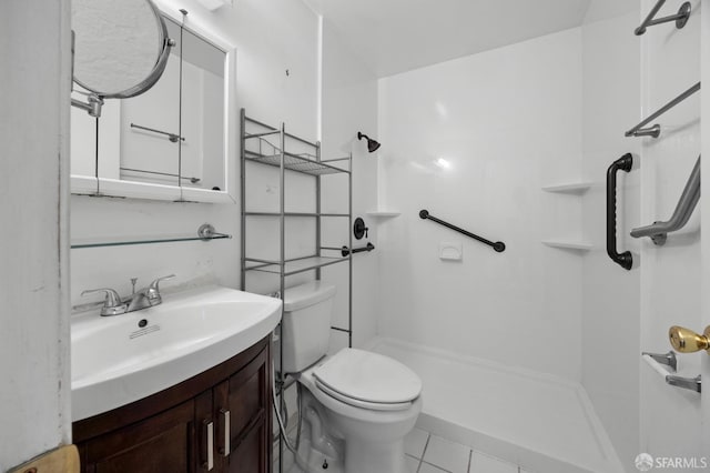 bathroom with tile patterned flooring, toilet, a shower, and vanity