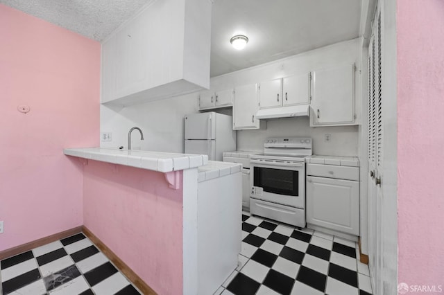 kitchen with a textured ceiling, white appliances, sink, tile countertops, and white cabinets