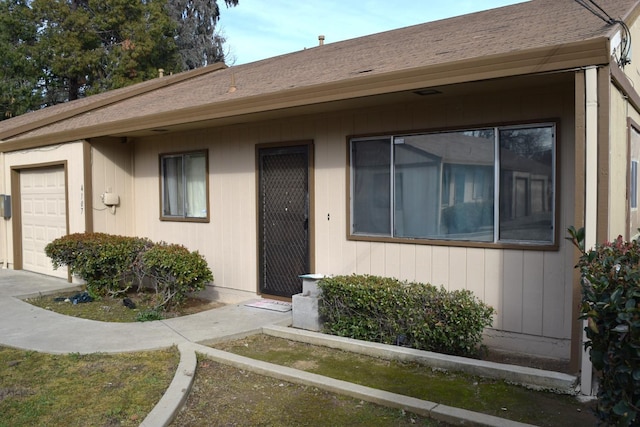 view of exterior entry with an attached garage