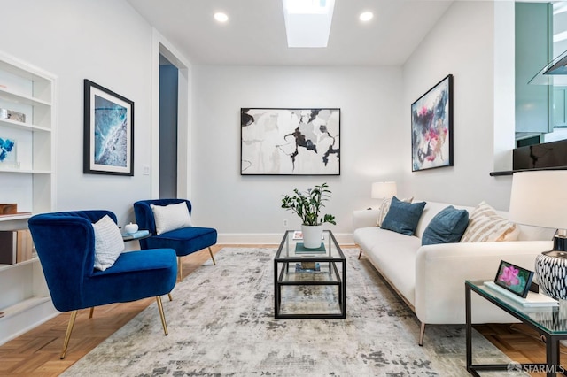 living room with a skylight, baseboards, and recessed lighting