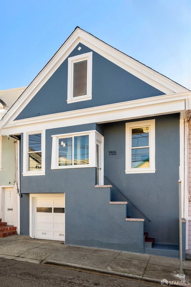 view of front of property featuring an attached garage and stucco siding