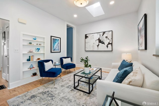 living room with a skylight, built in shelves, baseboards, and recessed lighting