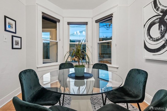 dining room featuring wood finished floors and baseboards