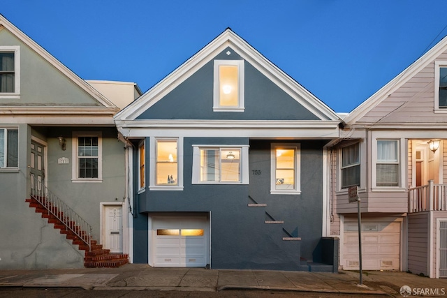 townhome / multi-family property featuring an attached garage and stucco siding