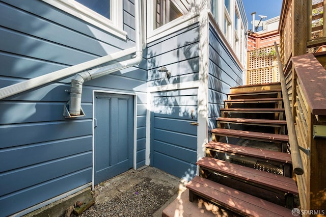 view of side of home featuring stairway