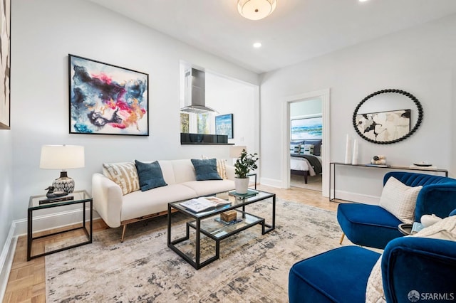 living area featuring recessed lighting and baseboards