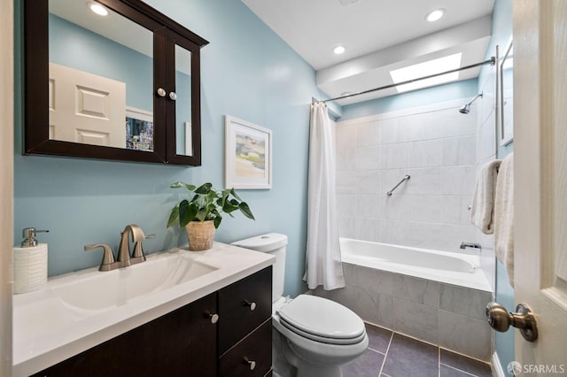 bathroom featuring tiled shower / bath, recessed lighting, toilet, vanity, and tile patterned flooring