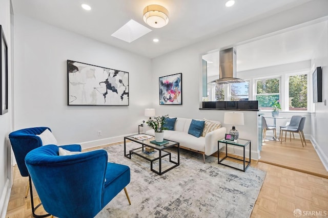 living area with a skylight, baseboards, and recessed lighting