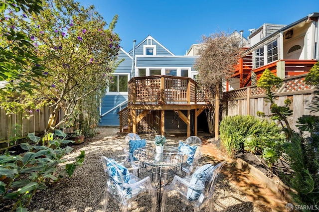 back of house with stairs, fence, and a deck