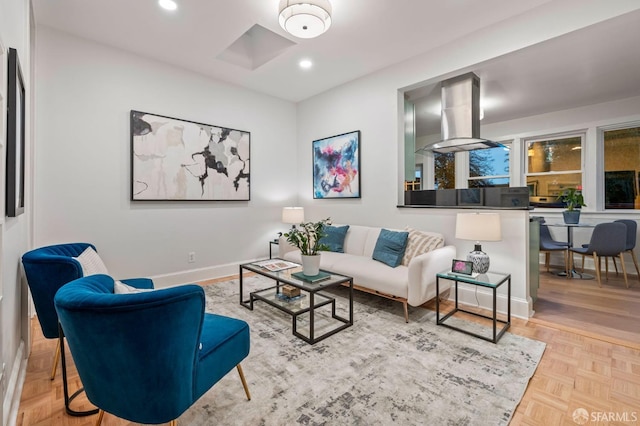 living area featuring baseboards and recessed lighting