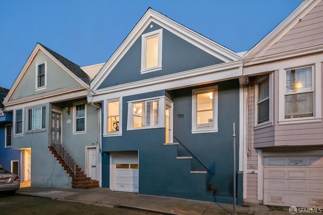 view of front of house with a garage and stucco siding