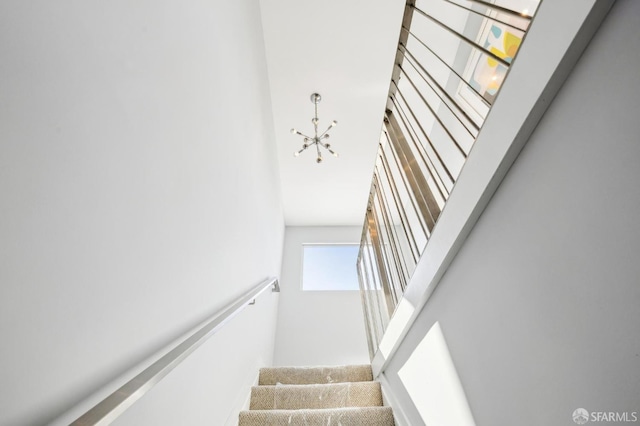 stairs featuring an inviting chandelier