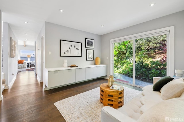 sitting room with baseboards, dark wood-style flooring, and recessed lighting