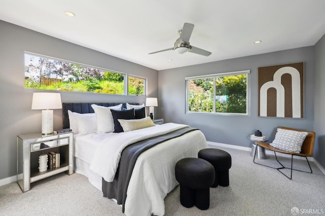 carpeted bedroom with multiple windows, recessed lighting, a ceiling fan, and baseboards