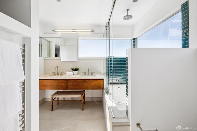 full bath featuring a sink, a combined bath / shower with rainfall shower, and double vanity