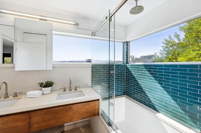 full bath with a sink and a combined bath / shower with rainfall shower