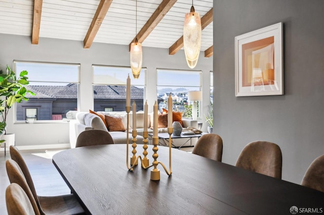 dining room with lofted ceiling with beams, wood ceiling, baseboards, and wood finished floors