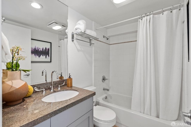 full bathroom with shower / bath combination with curtain, vanity, and toilet