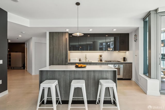 338 Main St Unit 6E, San Francisco, CA 94105 - bar with light wood-style floors, baseboards, recessed lighting, and hanging light fixtures