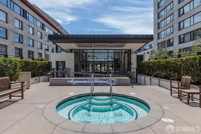 view of swimming pool with a community hot tub and a patio