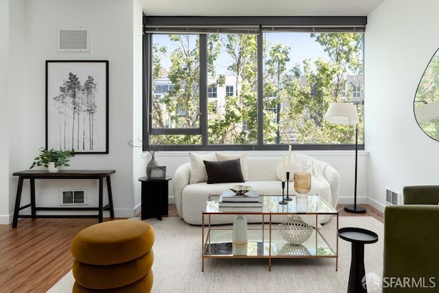 living area with wood finished floors and baseboards