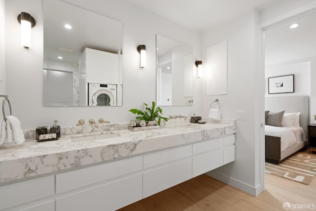 1070 Green St Unit 801, San Francisco, CA 94133 - bathroom with double vanity, wood finished floors, ensuite bathroom, recessed lighting, and washer / clothes dryer