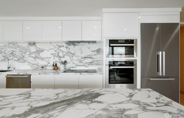 1070 Green St Unit 801, San Francisco, CA 94133 - kitchen with appliances with stainless steel finishes, modern cabinets, white cabinetry, light stone countertops, and tasteful backsplash