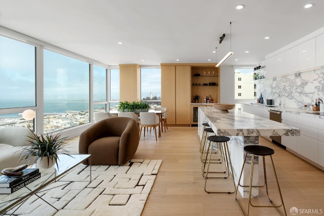 1070 Green St Unit 801, San Francisco, CA 94133 - kitchen featuring modern cabinets, a center island, white cabinets, open shelves, and light wood finished floors