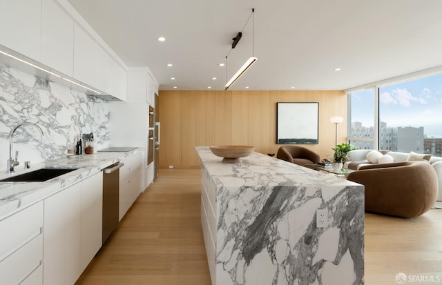 1070 Green St Unit 801, San Francisco, CA 94133 - kitchen featuring a kitchen island, modern cabinets, open floor plan, light wood finished floors, and recessed lighting