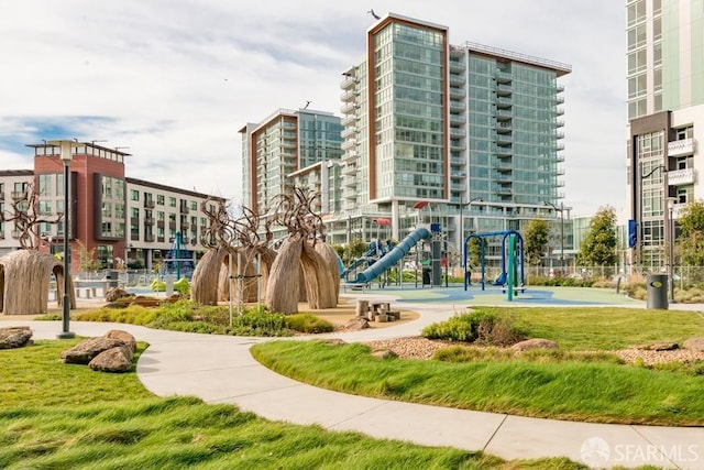 view of home's community with a playground and a lawn