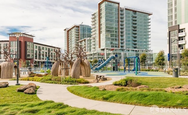 view of home's community with a playground and a lawn