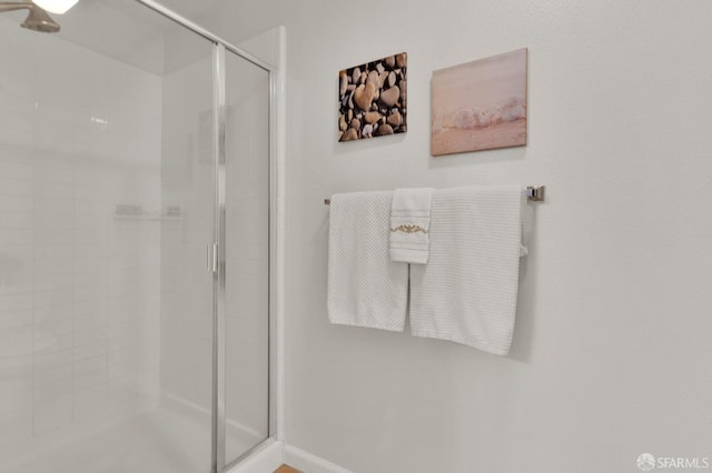 bathroom with a shower with door