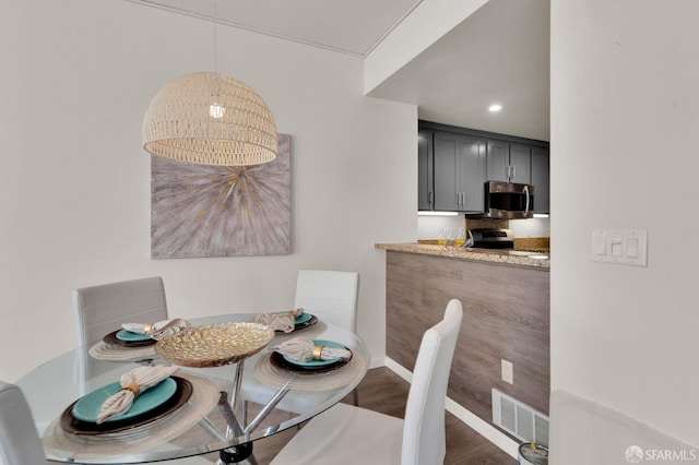 dining area featuring dark hardwood / wood-style floors