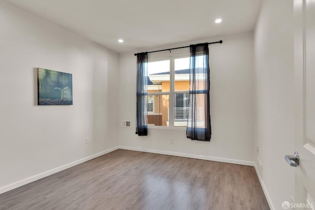 unfurnished room with light wood-type flooring