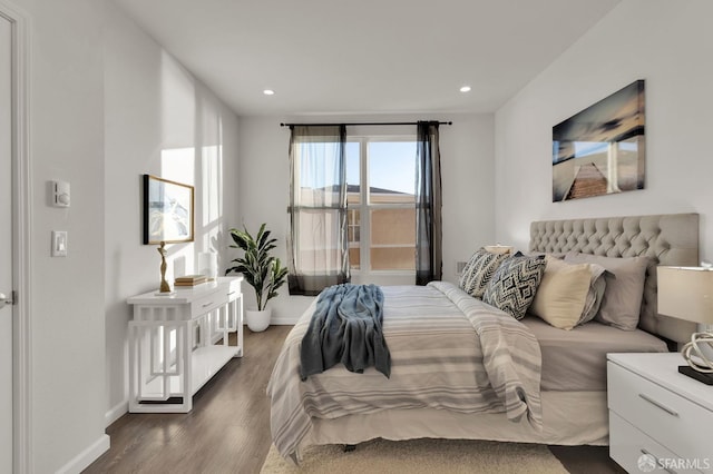 bedroom with dark wood-type flooring