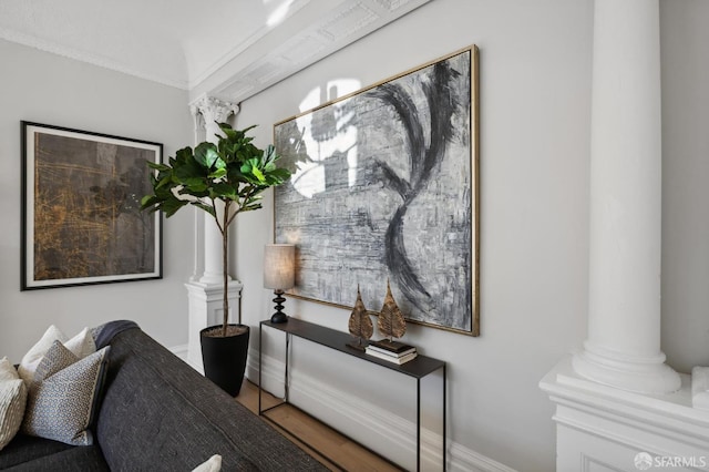 interior space featuring crown molding and ornate columns