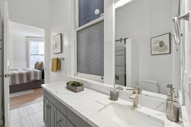 bathroom featuring tile patterned floors, an enclosed shower, vanity, and toilet