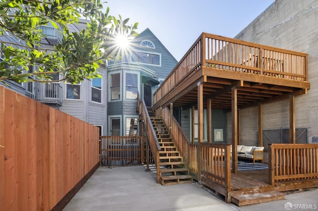 back of property featuring a patio area, a deck, and an outdoor living space