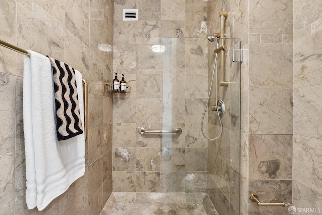 full bathroom with visible vents and a tile shower