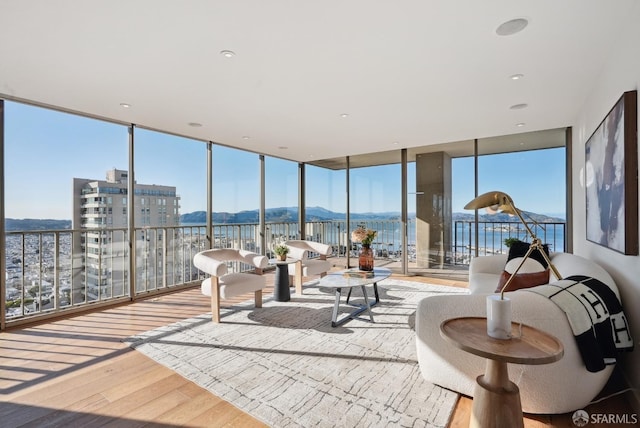 sunroom / solarium featuring a healthy amount of sunlight and a mountain view