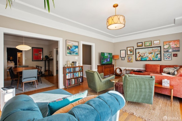 living room featuring ornamental molding and wood-type flooring