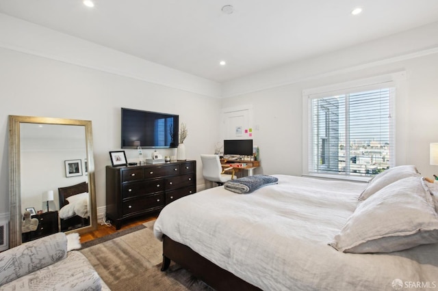 bedroom with dark hardwood / wood-style floors