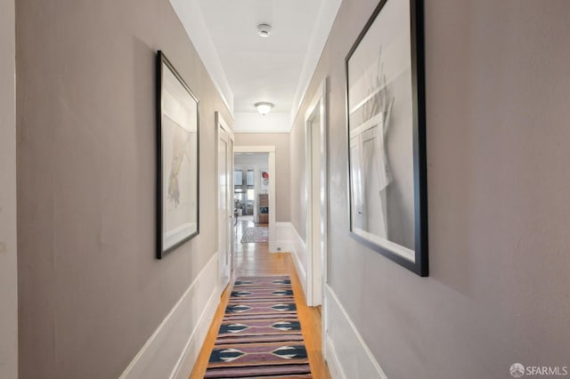 hallway with hardwood / wood-style flooring