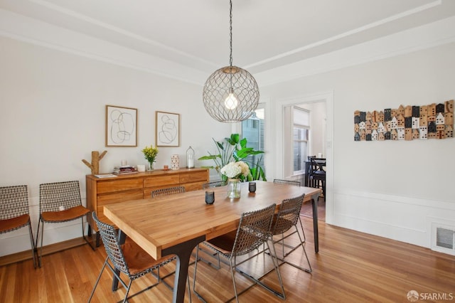 dining space with hardwood / wood-style floors