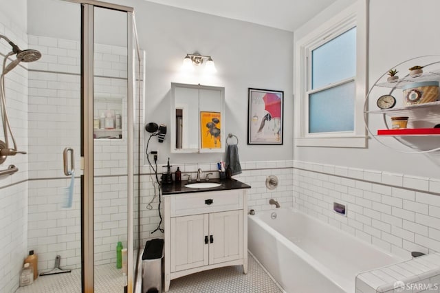 bathroom featuring shower with separate bathtub, tile patterned floors, and vanity