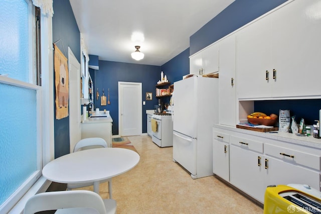 kitchen featuring sink, white appliances, a wealth of natural light, and white cabinets